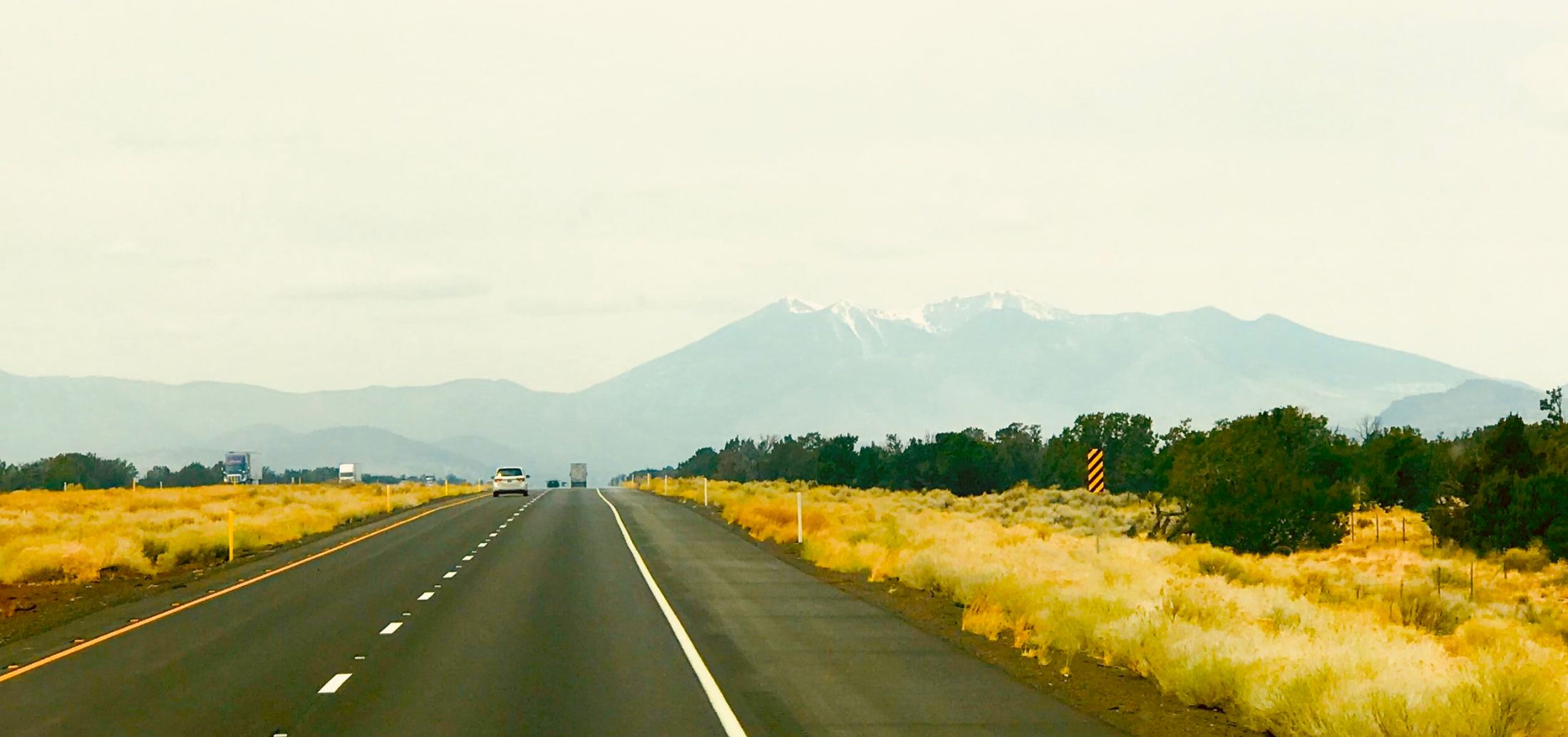 An open road leading toward the mountains